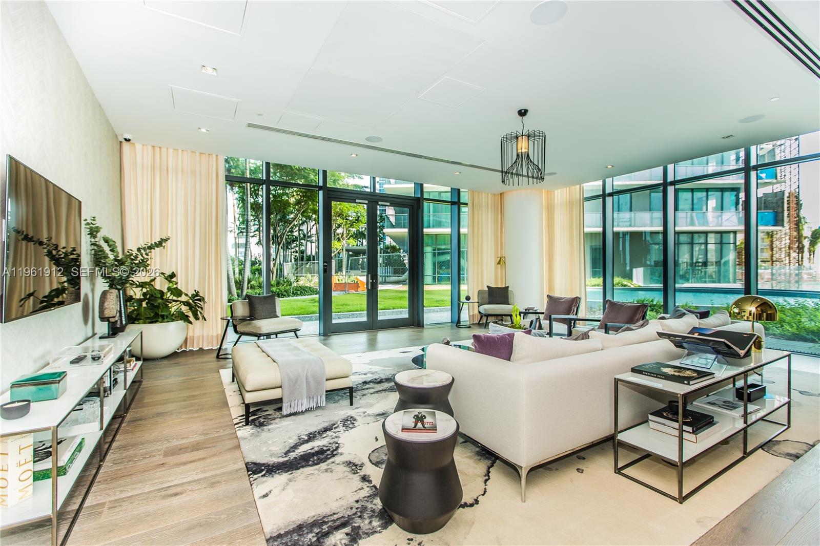 650 Northeast 32nd Street, Unit 2205 Miami, FL 33137 - Photo 42 of 56 a living room with furniture and floor to ceiling windows