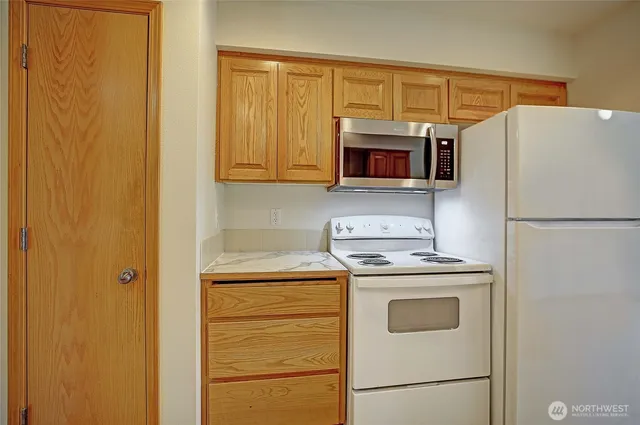 a kitchen with a refrigerator stove and microwave