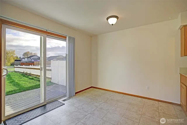 a view of an empty room and wooden floor