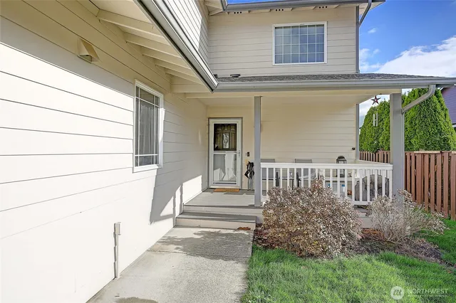 a view of a house with a small yard and wooden floor and fence