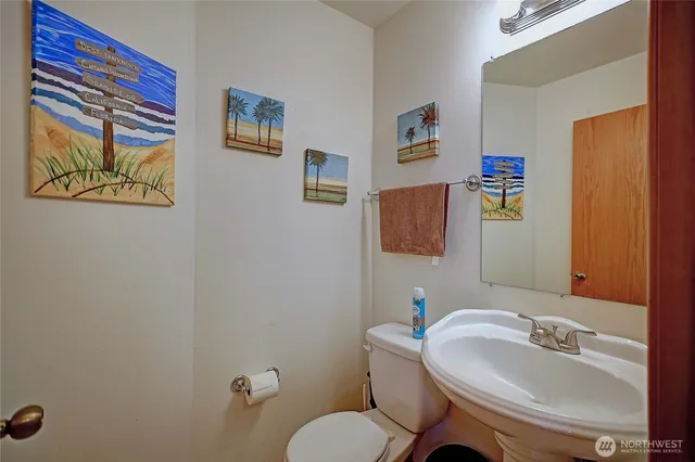 a bathroom with a sink mirror and toilet
