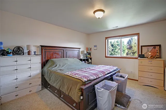 a bedroom with a bed and window