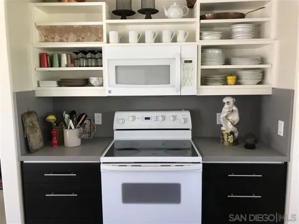 a white stove top oven sitting inside of a kitchen