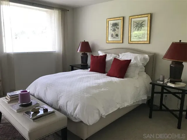 a view of a field with grass and trees