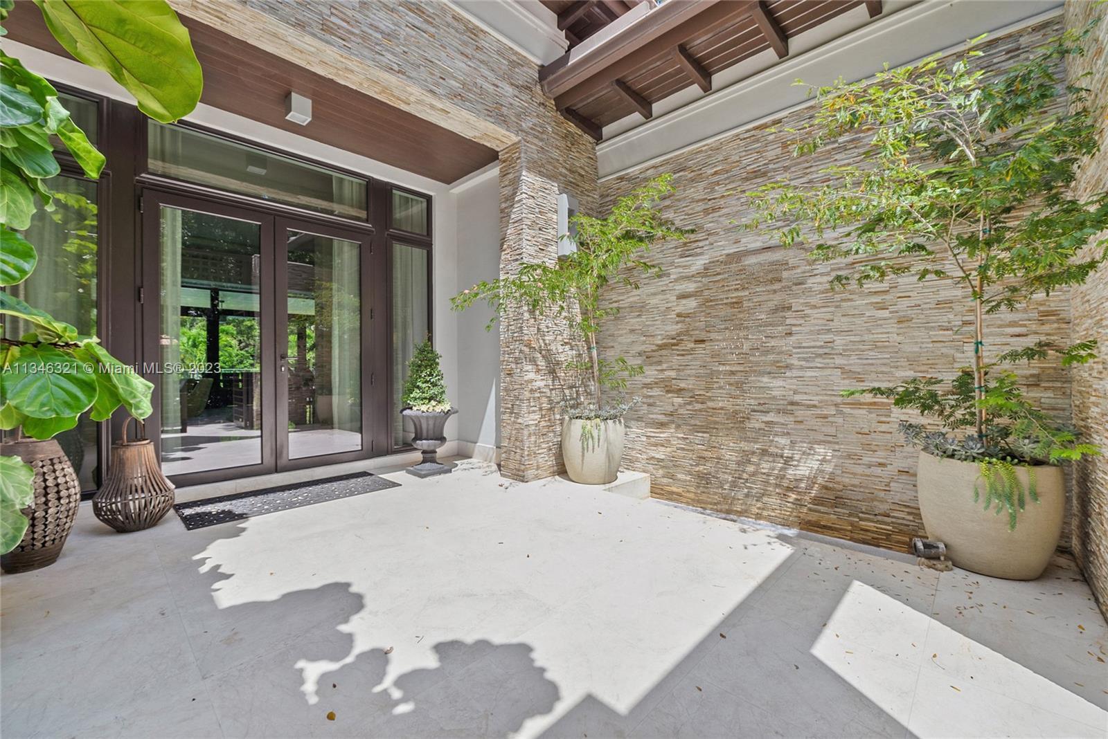 810 Jeronimo Drive Coral Gables, FL 33146 - Photo 11 of 41 a brick building with a bench in front of house