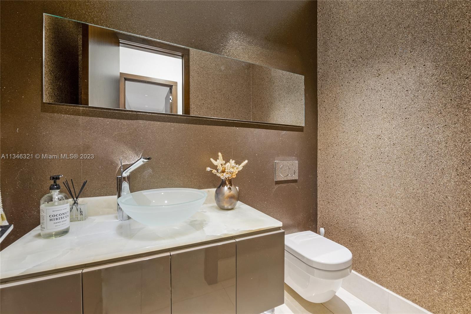 810 Jeronimo Drive Coral Gables, FL 33146 - Photo 23 of 41 a bathroom with a sink a toilet and mirror