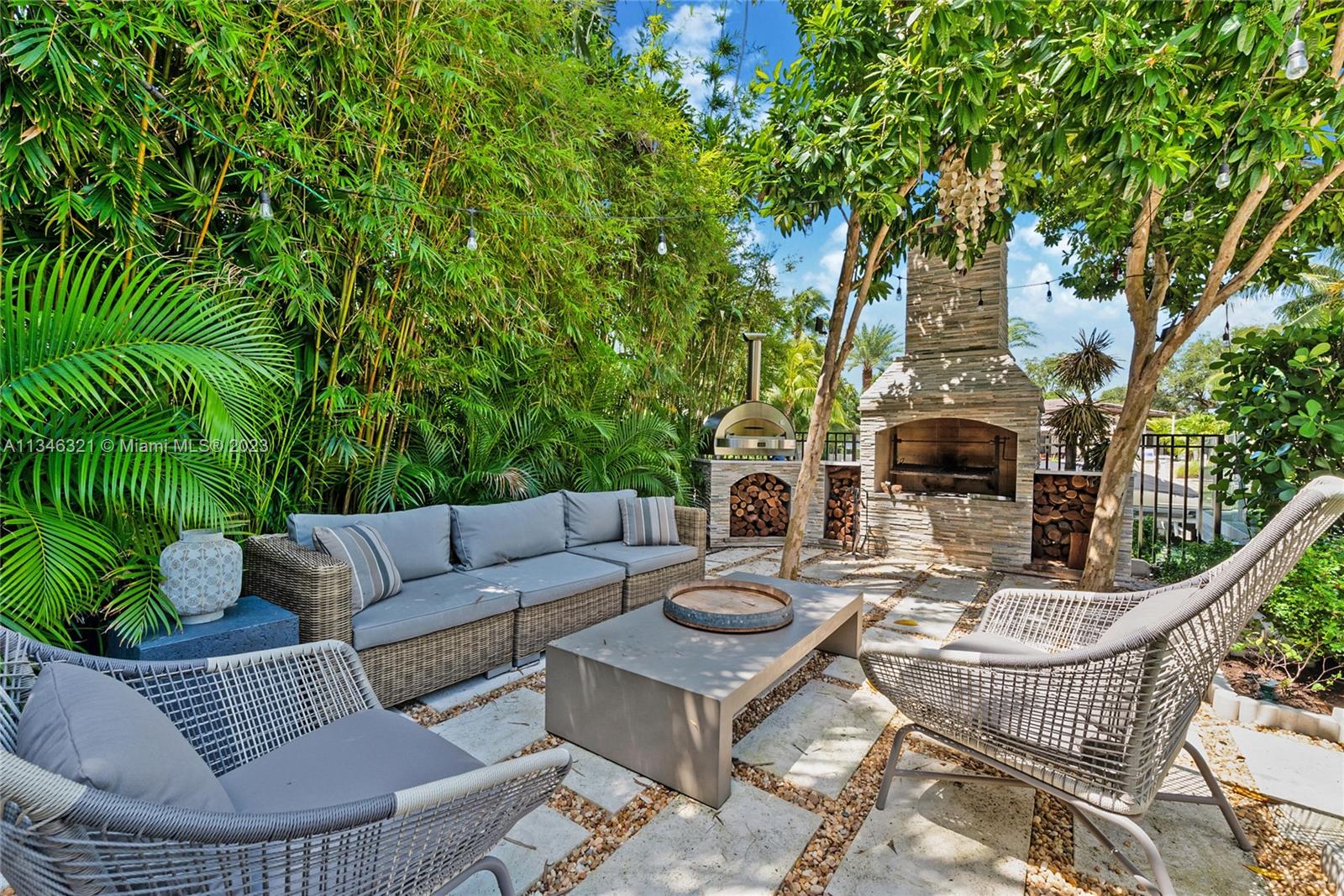 810 Jeronimo Drive Coral Gables, FL 33146 - Photo 33 of 41 a view of a patio with couches table and chairs and potted plants
