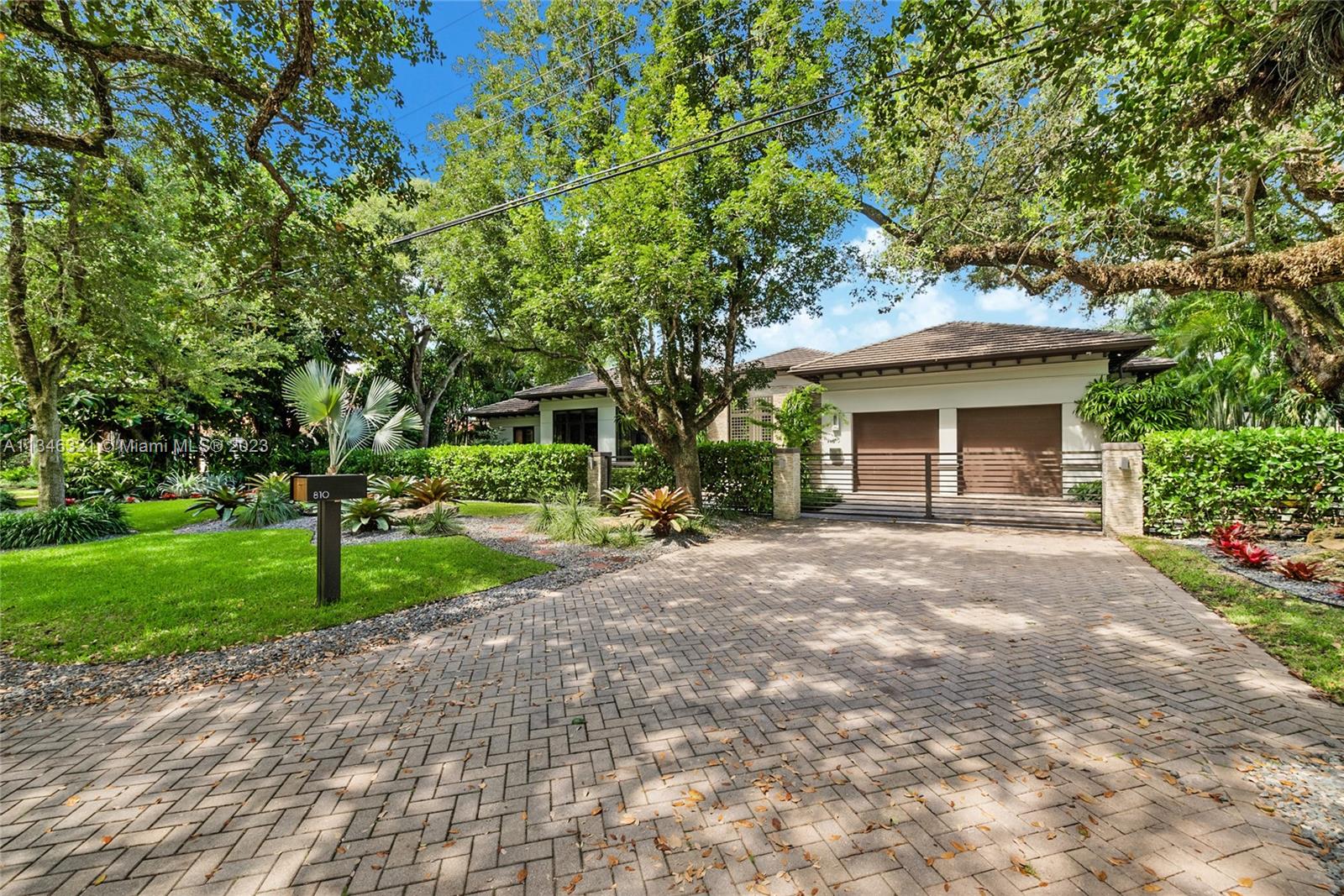 810 Jeronimo Drive Coral Gables, FL 33146 - Photo 9 of 41 a view of a house with a yard and large tree