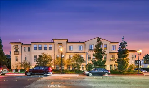 a city street with a building and a street in the roadside