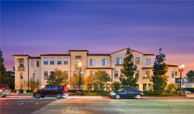 a city street with a building and a street in the roadside