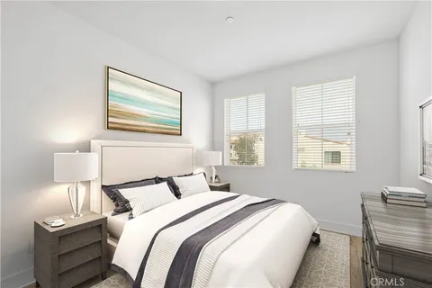 a bedroom with a bed and a lamp next to a window