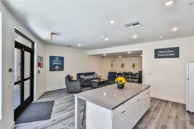 a view of a living room and kitchen island
