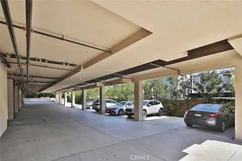 a view of parking garage with cars