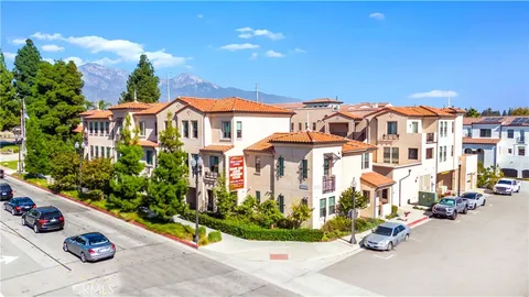 front view of a building with a lot of flower plants