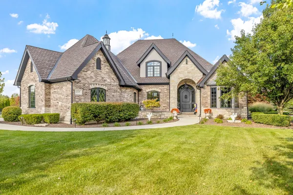a front view of a house with swimming pool having outdoor seating