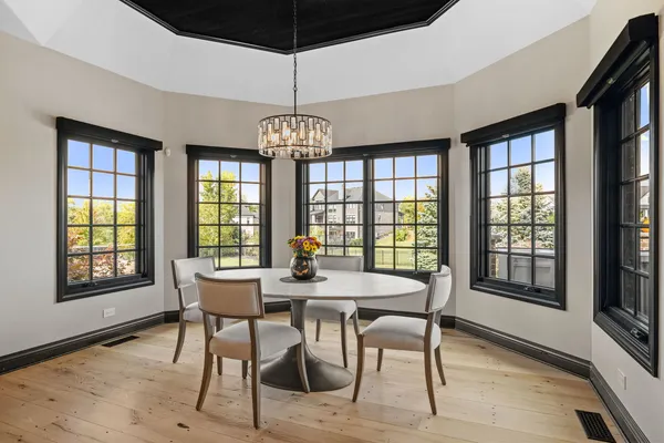 a view of a dining room with furniture wooden floor and chandelier