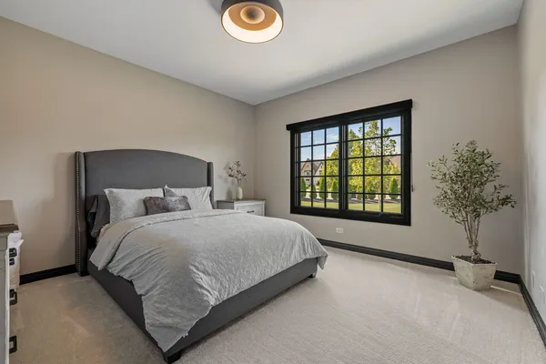 a en suite bathroom with a granite countertop sink and a mirror