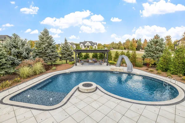 an aerial view of a house with a swimming pool