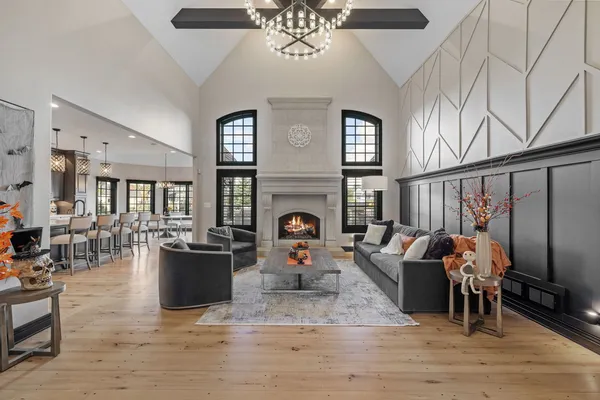 a living room with fireplace furniture and a wooden floor