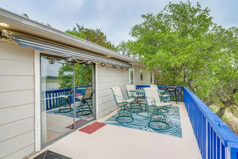 a view of balcony with furniture and garden