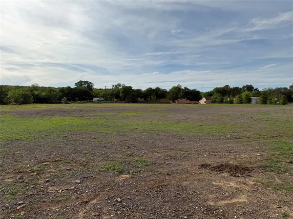 a view of a field with an ocean