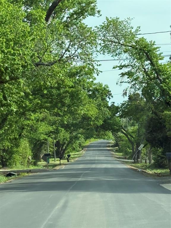 2 Kennedale New Hope Road Kennedale, TX 76060 - Photo 5 of 5 View of asphalt street featuring view of wooded area and curbs