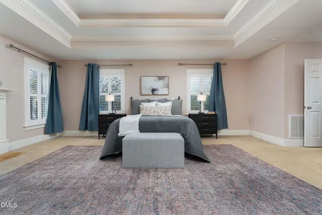 a bedroom with a bed lamp and a large window