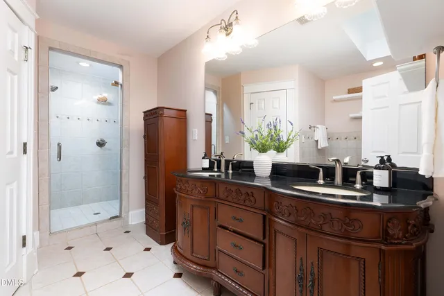 a bathroom with a sink a double vanity and shower