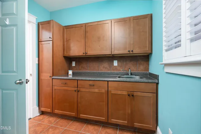 a kitchen with granite countertop cabinets and window