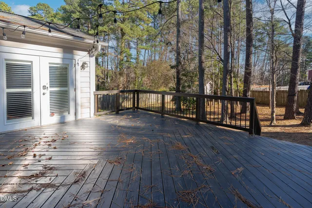 a view of outdoor space with deck and floor to ceiling window