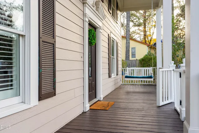 a view of a balcony with wooden floor and fence