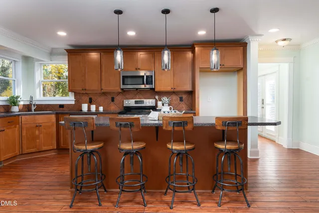 a large kitchen with a table and chairs