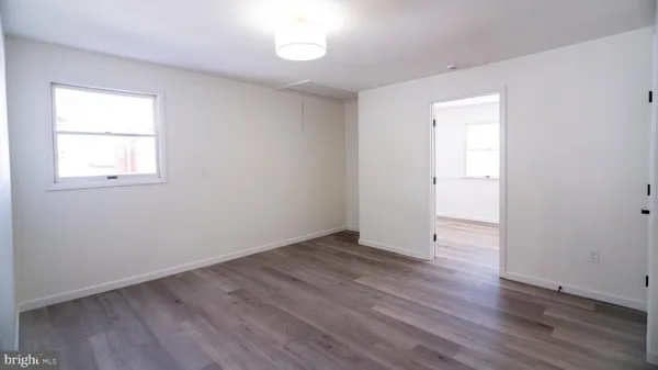 a view of a room with wooden floor and window