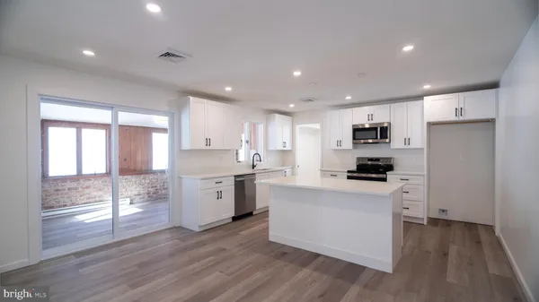 a kitchen with stove a sink and a refrigerator