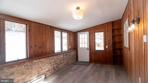 wooden floor in an empty room with a window