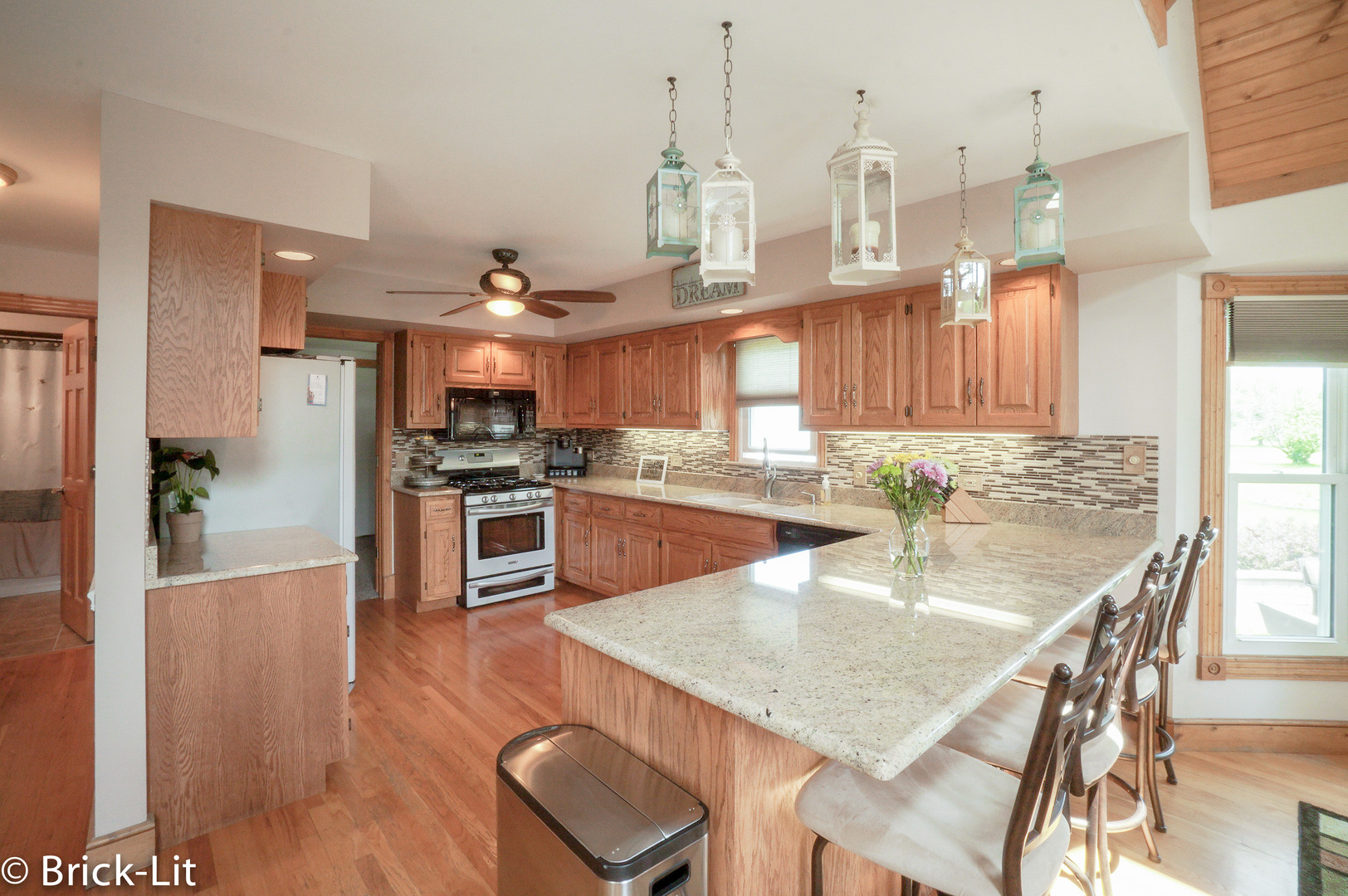 23959 South Schoolhouse Road Manhattan, IL 60442 - Photo 14 of 31 a kitchen with stainless steel appliances granite countertop a stove top oven a sink a dining table and chairs