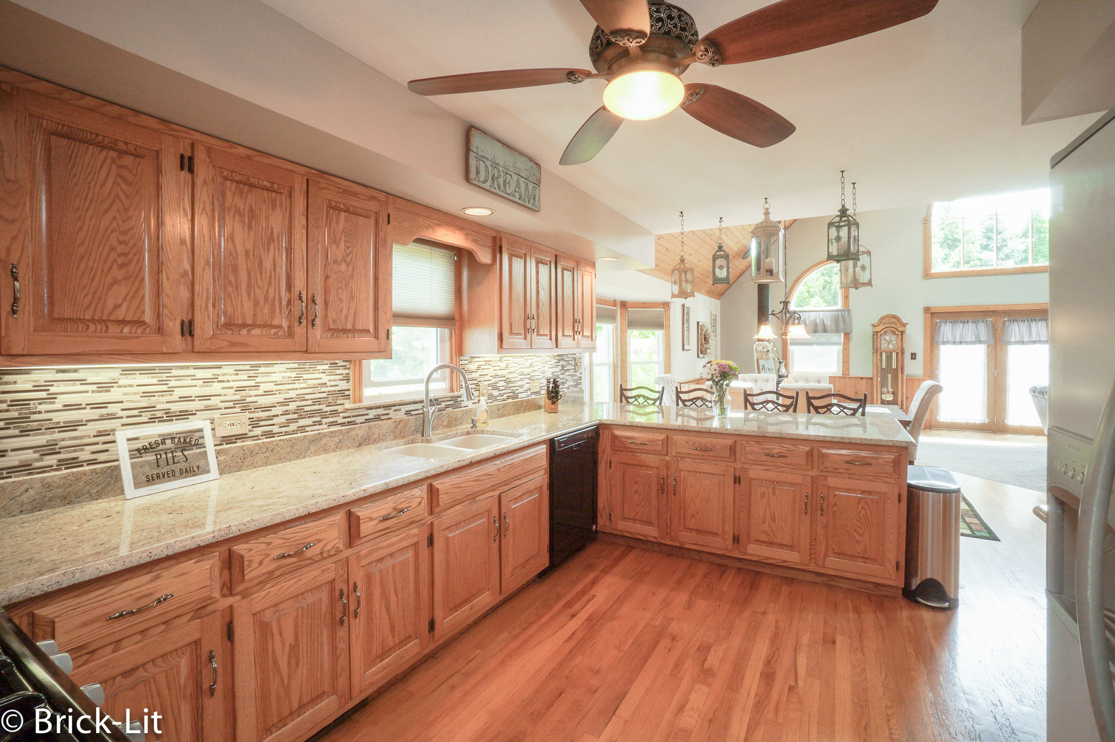 23959 South Schoolhouse Road Manhattan, IL 60442 - Photo 15 of 31 a large kitchen with granite countertop a large window a sink and stainless steel appliances