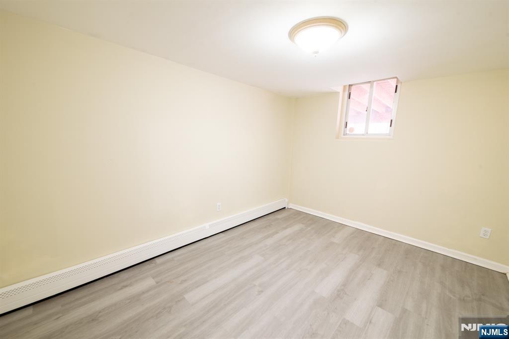 412 Walker Street, Unit 1 Fairview, NJ 07022 - Photo 9 of 10 an empty room with a window