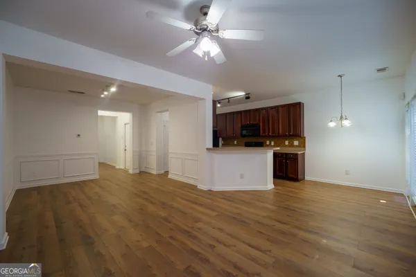 a kitchen with stainless steel appliances granite countertop a sink stove and cabinets