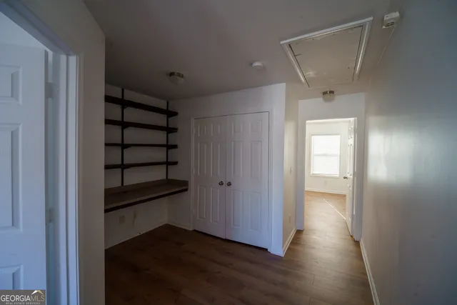 a view of a room with wooden floor and window