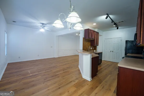 a kitchen with kitchen island a counter space a sink and appliances