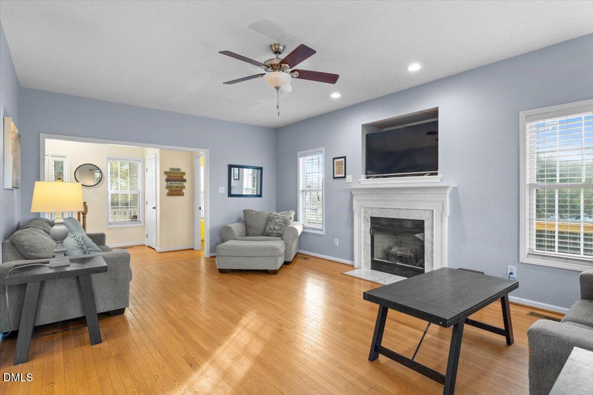 6512 Cablewood Drive Raleigh, NC 27603 - Photo 11 of 41 a living room with furniture fireplace and a flat screen tv