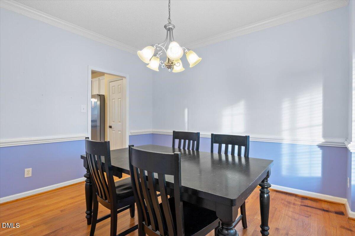 6512 Cablewood Drive Raleigh, NC 27603 - Photo 18 of 41 a view of a dining room with furniture and wooden floor