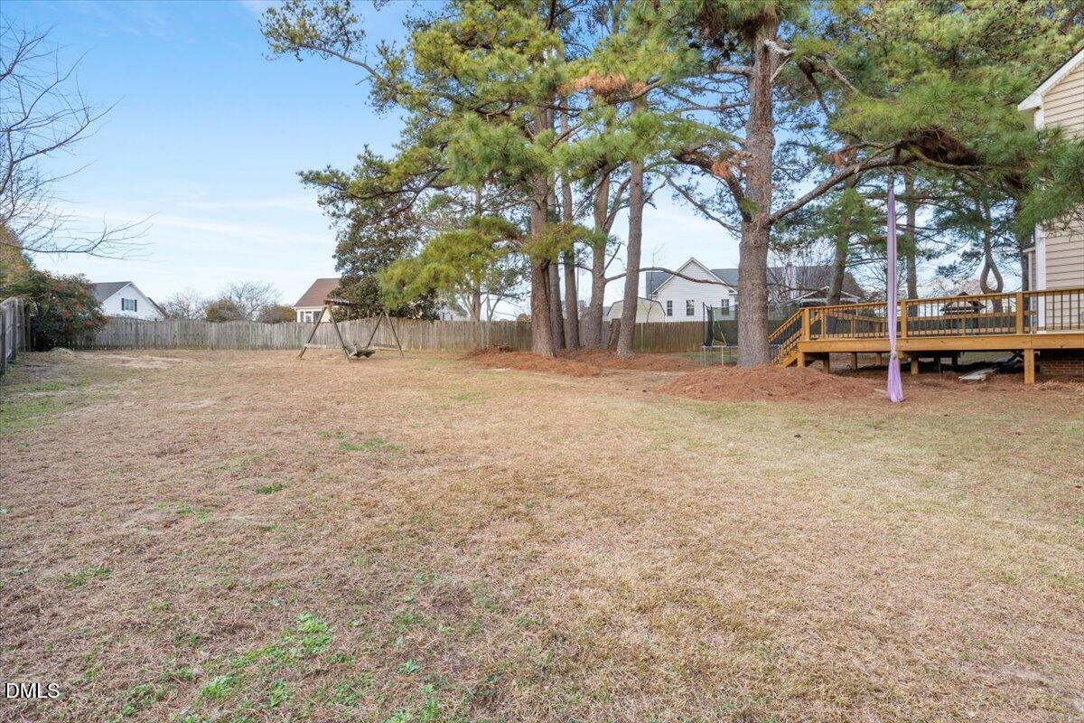 6512 Cablewood Drive Raleigh, NC 27603 - Photo 34 of 41 a backyard of a house with table and chairs