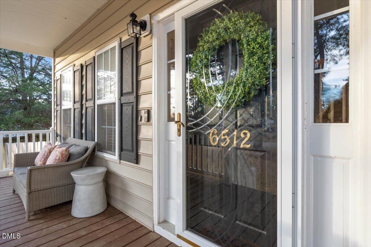 6512 Cablewood Drive Raleigh, NC 27603 - Photo 5 of 41 a view of a balcony with chair and glass door