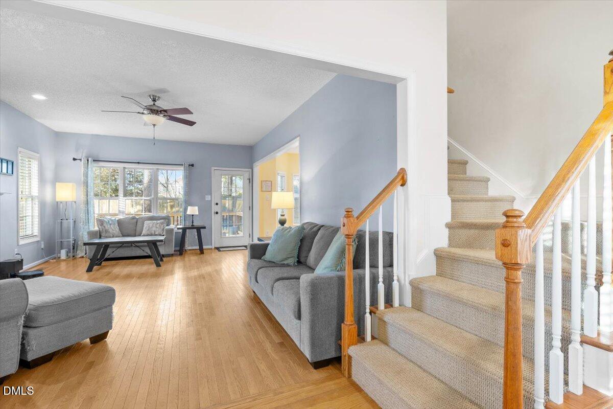 6512 Cablewood Drive Raleigh, NC 27603 - Photo 7 of 41 a living room with furniture and a chandelier