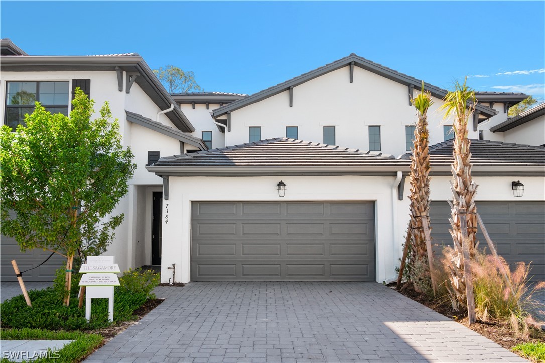 a front view of a house with garage
