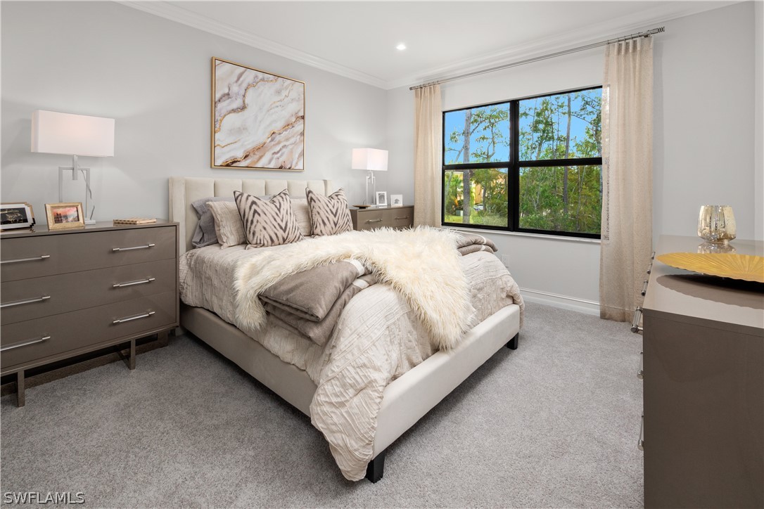 7587 Morgan Way Naples, FL 34119 - Photo 18 of 29 a bed sitting in a bedroom next to a window