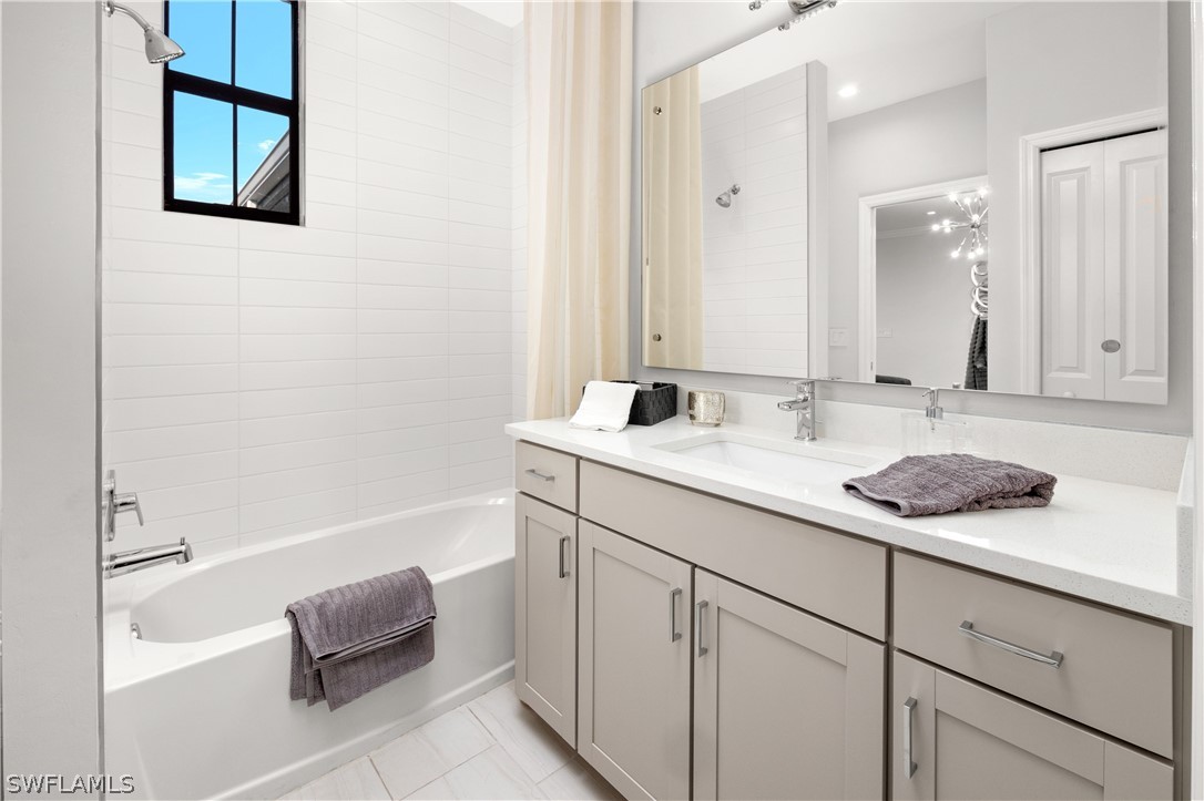 7587 Morgan Way Naples, FL 34119 - Photo 19 of 29 a bathroom with a sink and a bathtub