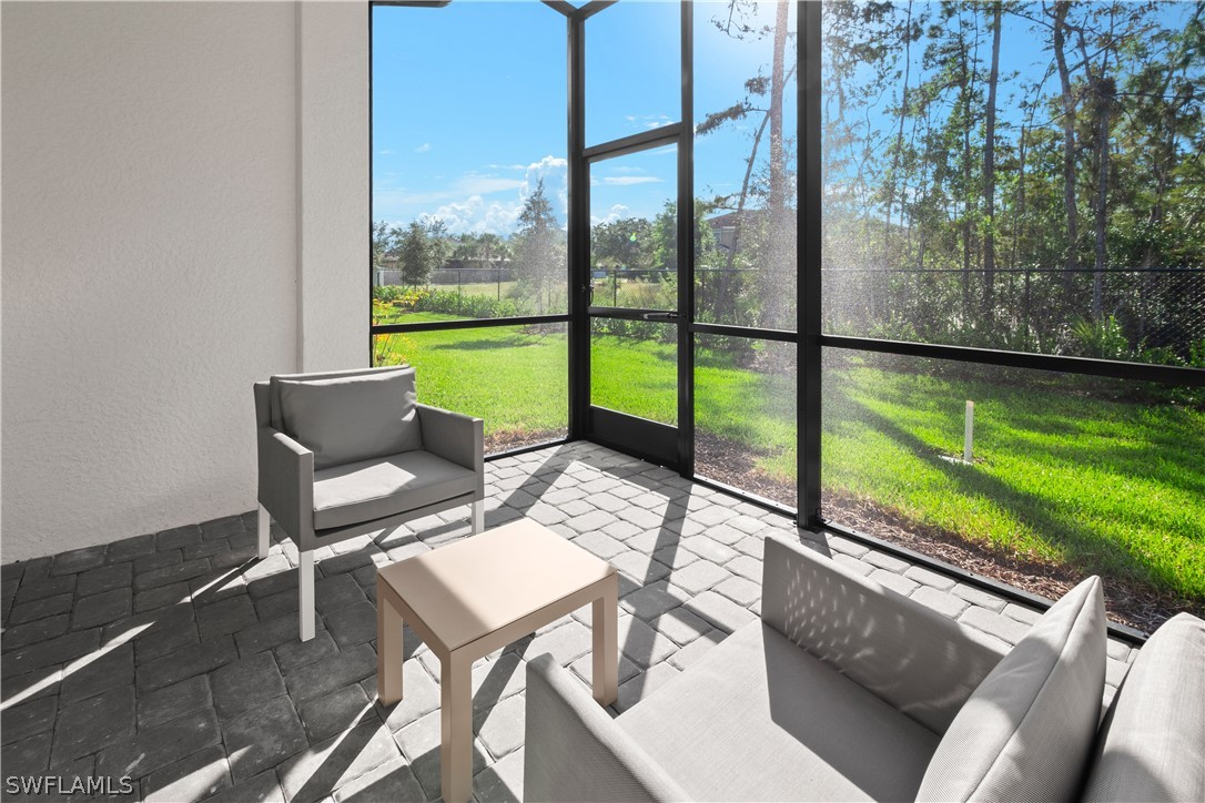 7587 Morgan Way Naples, FL 34119 - Photo 4 of 29 a roof deck with table and chairs and garden view